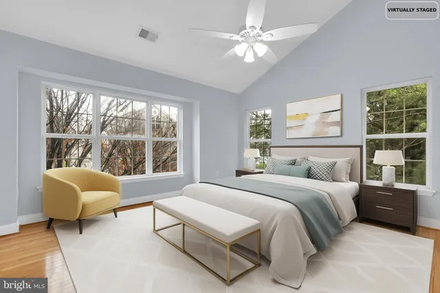 a bedroom with a bed a couch and a window