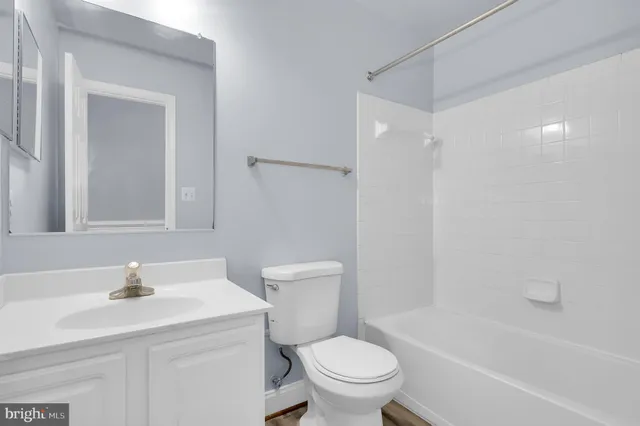 a bathroom with a sink toilet vanity and shower