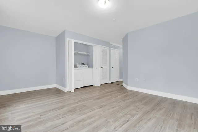 a view of an empty room and wooden floor