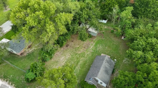 an aerial view of a house with a yard and lake view