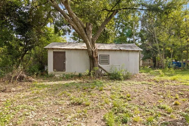 a house with trees in the background