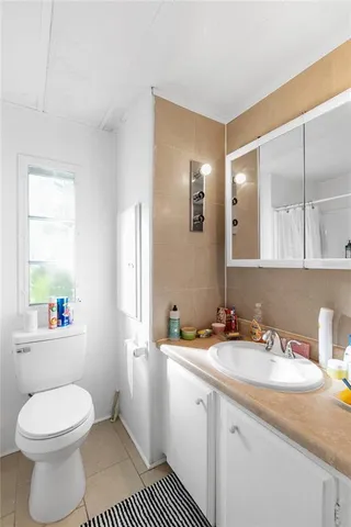 a bedroom with furniture and a large window