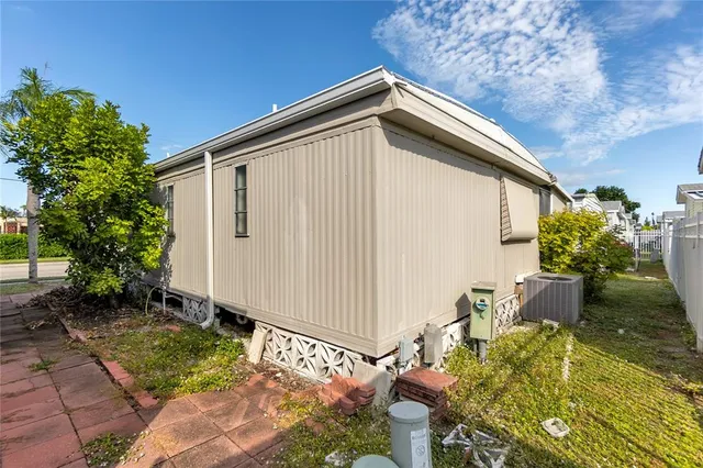 a view of a patio with dining table and chairs under an umbrella
