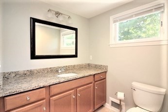 2 McAdams Road Framingham, MA 01701 - Photo 11 of 17 a bathroom with a toilet sink and mirror