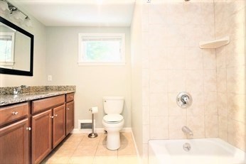 2 McAdams Road Framingham, MA 01701 - Photo 12 of 17 a bathroom with a sink a toilet and mirror