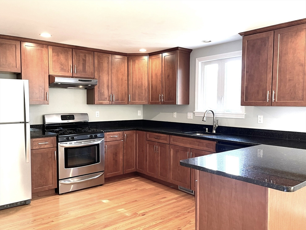 2 McAdams Road Framingham, MA 01701 - Photo 2 of 17 a kitchen with granite countertop a stove and a sink