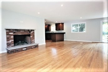 2 McAdams Road Framingham, MA 01701 - Photo 4 of 17 a view of an empty room with a fireplace and a window