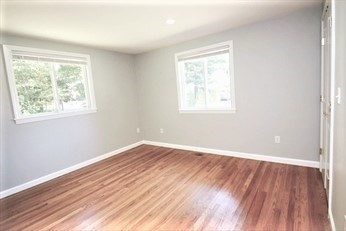 2 McAdams Road Framingham, MA 01701 - Photo 9 of 17 an empty room with wooden floor and windows