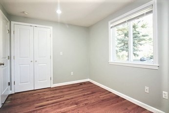 2 McAdams Road Framingham, MA 01701 - Photo 10 of 17 a view of an empty room with wooden floor and a window