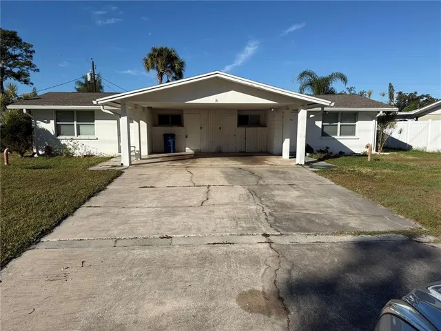 a front view of a house with a garden and yard
