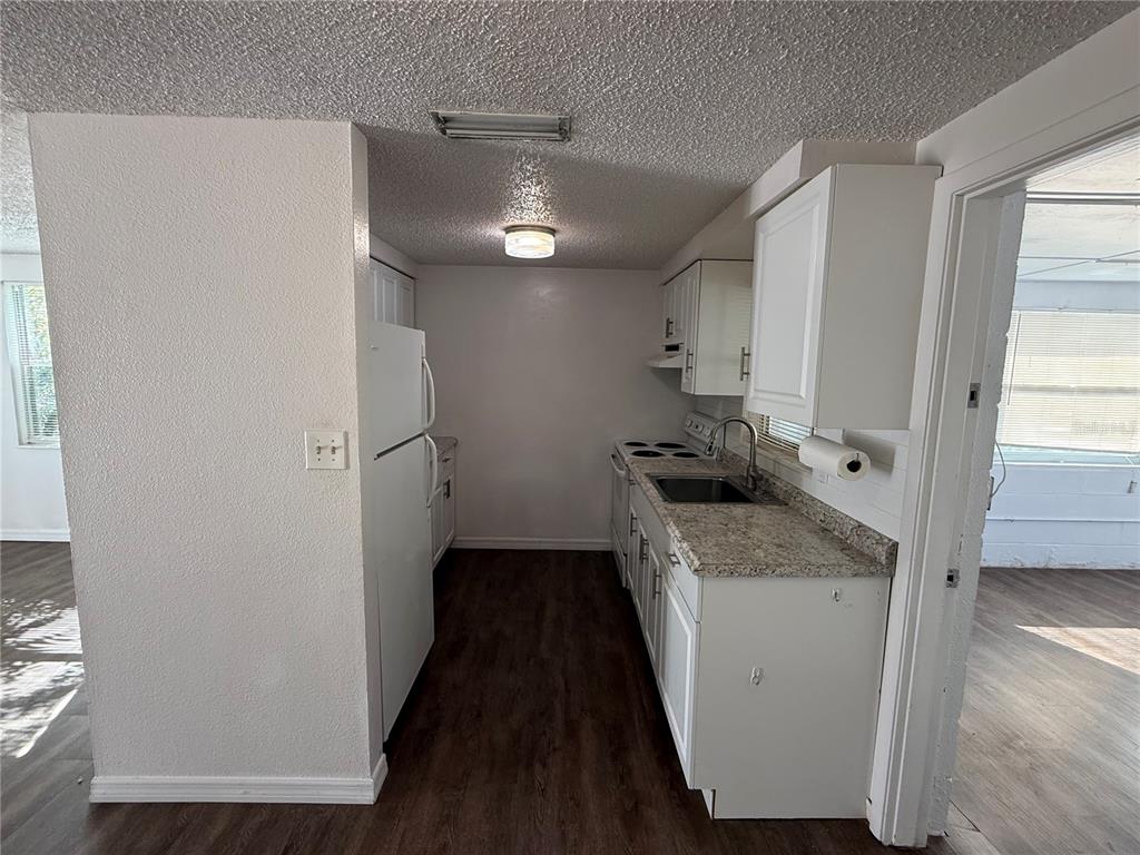 5320 South Lockwood Ridge Road Sarasota, FL 34231 - Photo 13 of 29 a kitchen with a refrigerator and a stove