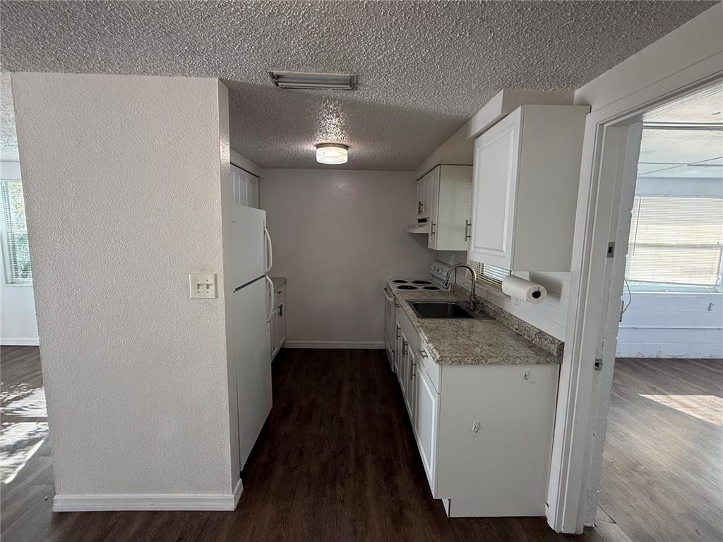 5320 South Lockwood Ridge Road Sarasota, FL 34231 - Photo 16 of 29 a kitchen with a refrigerator and a stove