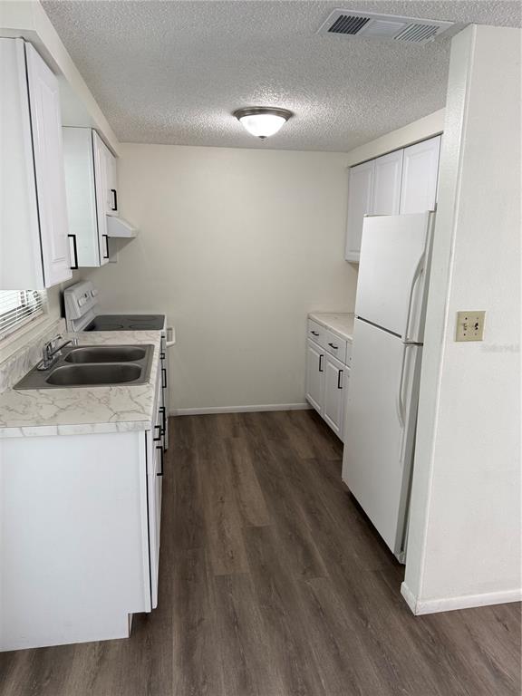5320 South Lockwood Ridge Road Sarasota, FL 34231 - Photo 17 of 29 a view of a storage and utility room with wooden floor