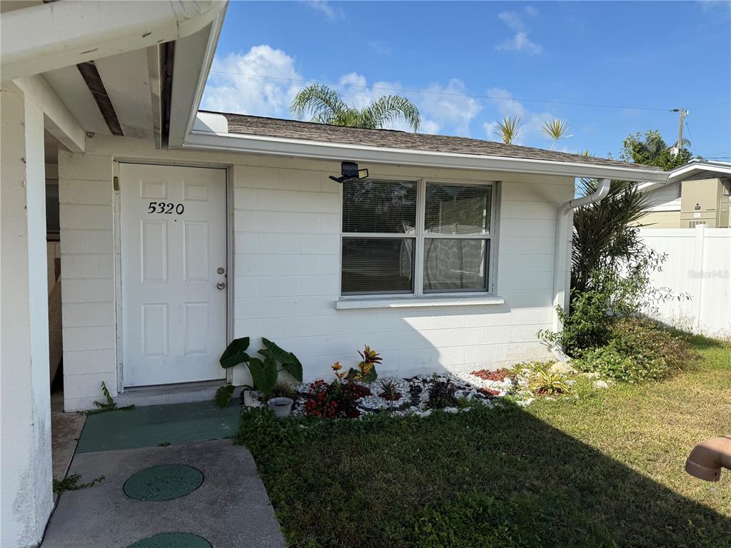 5320 South Lockwood Ridge Road Sarasota, FL 34231 - Photo 2 of 29 a front view of a house with garden