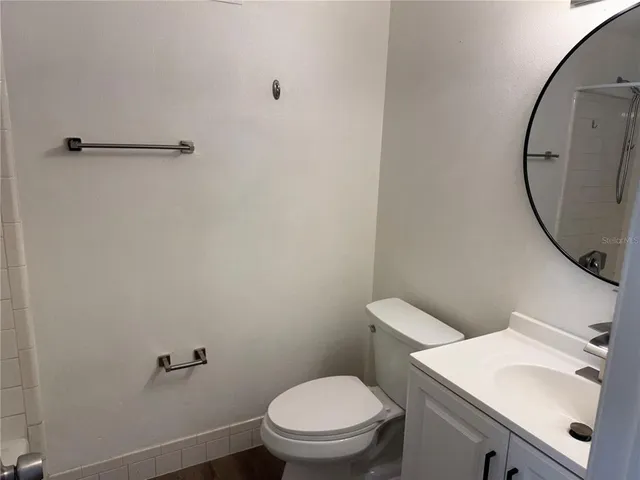 a view of a room with an empty space and a ceiling fan