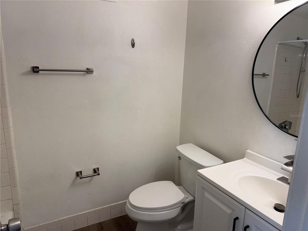 5320 South Lockwood Ridge Road Sarasota, FL 34231 - Photo 25 of 29 a bathroom with a sink toilet and a mirror