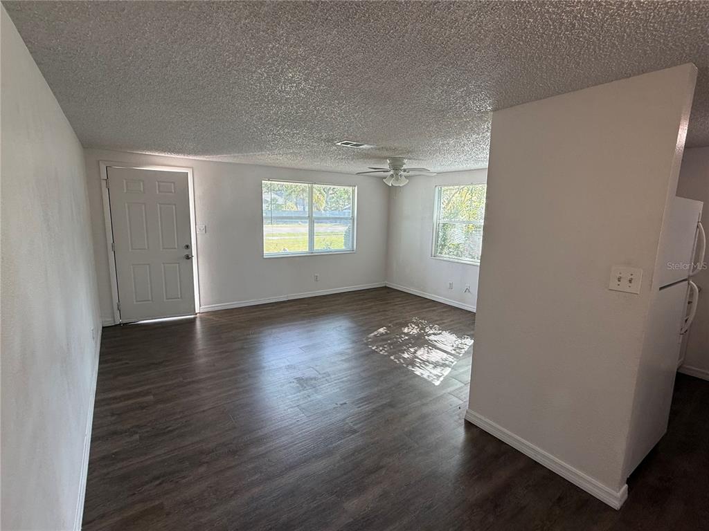 5320 South Lockwood Ridge Road Sarasota, FL 34231 - Photo 4 of 29 an empty room with wooden floor and windows