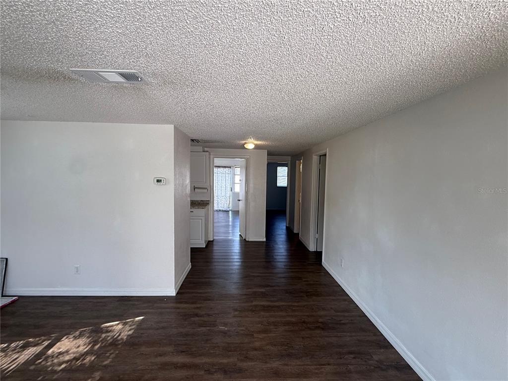 5320 South Lockwood Ridge Road Sarasota, FL 34231 - Photo 7 of 29 a view of a hallway with wooden floor
