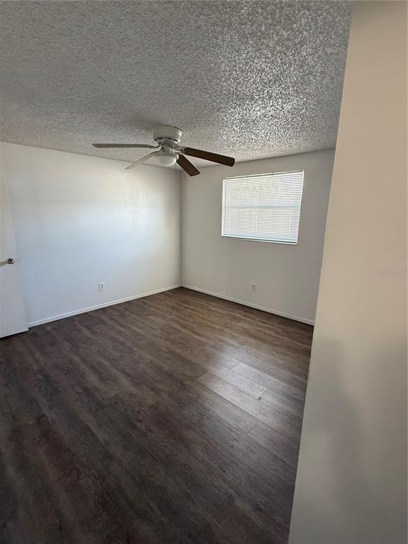 5320 South Lockwood Ridge Road Sarasota, FL 34231 - Photo 8 of 29 an empty room with a wooden floor and windows