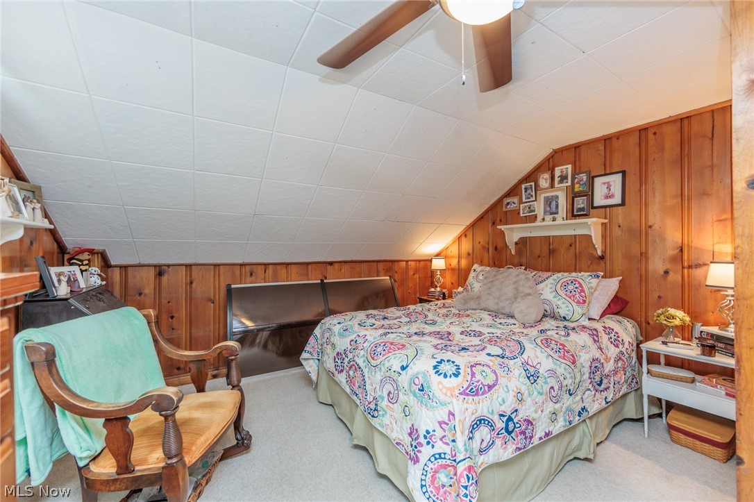 5364 Summit Road Lyndhurst, OH 44124 - Photo 18 of 42 Attic room featuring angled ceilings, wood-paneled walls, and light-toned carpeting