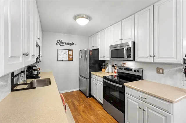 a bedroom with a bed a dresser and chair