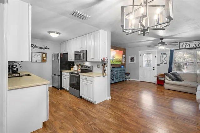 a bathroom with a granite countertop sink a toilet and a mirror