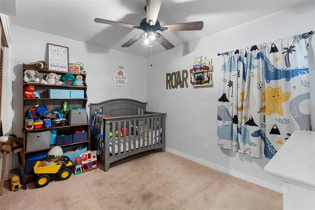 a bedroom with bed and a chair