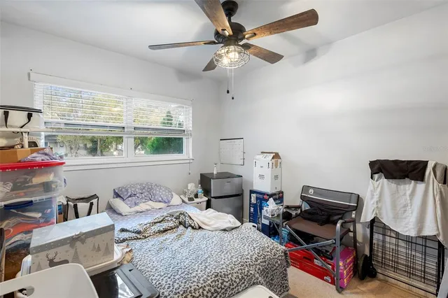 a front view of a house with a yard and potted plants