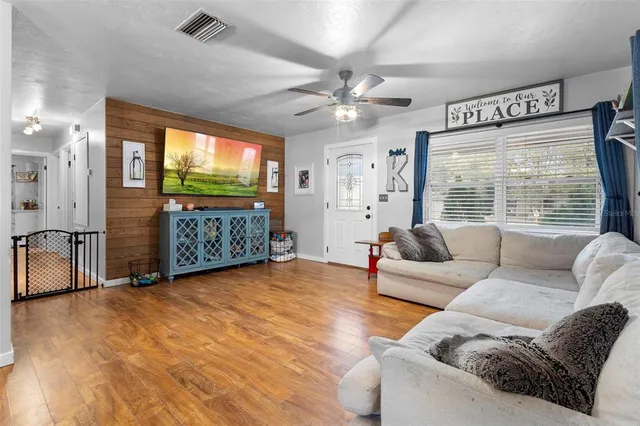 a living room with furniture and wooden floor