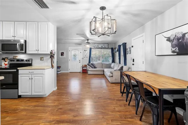 a kitchen with stainless steel appliances a stove sink microwave and cabinets