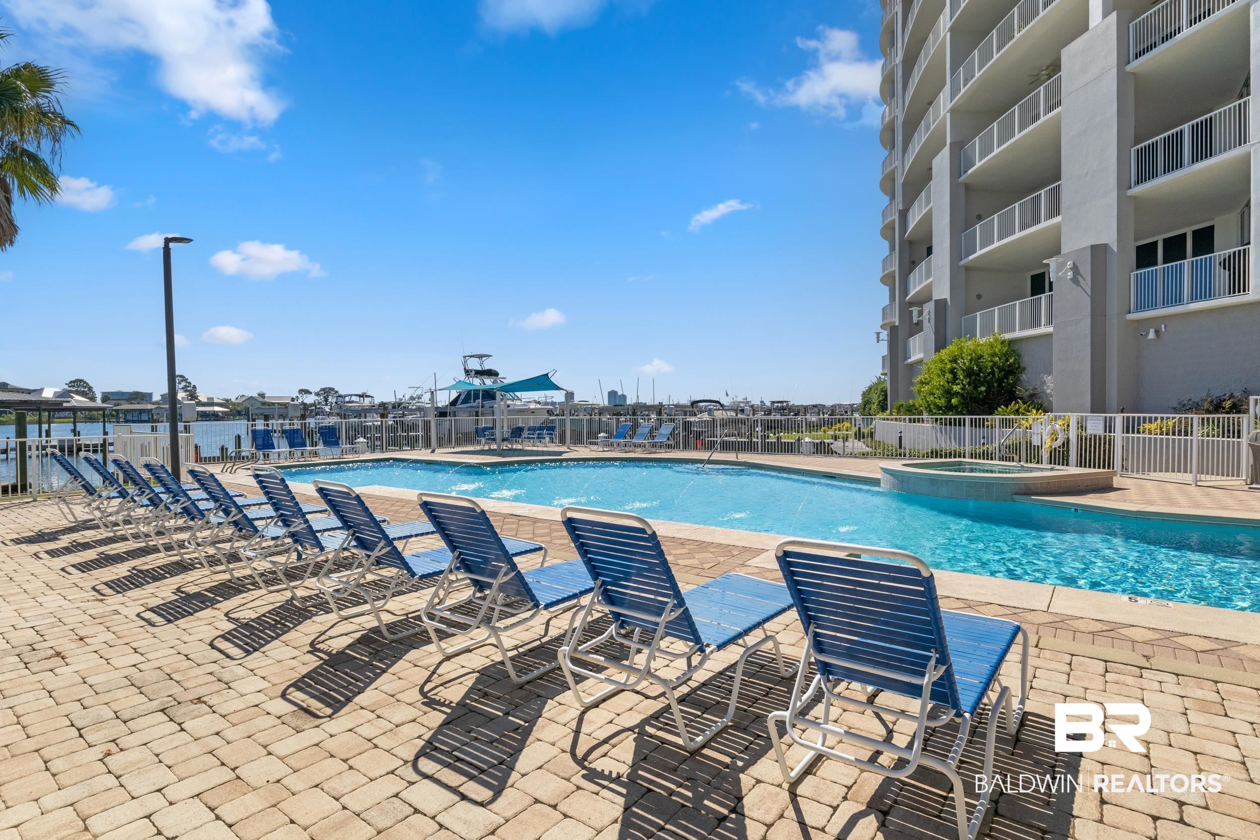 28250 Canal Road, Unit 307 Orange Beach, AL 36561 - Photo 11 of 56 Community pool with a patio area and a hot tub