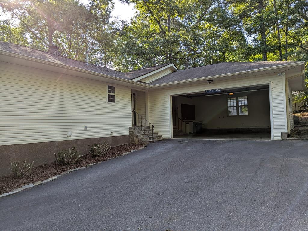 283 Deaver Cove Road Blairsville, GA 30512 - Photo 14 of 27 Side view, Full fenced yard to the pups. Nice storage shed.
