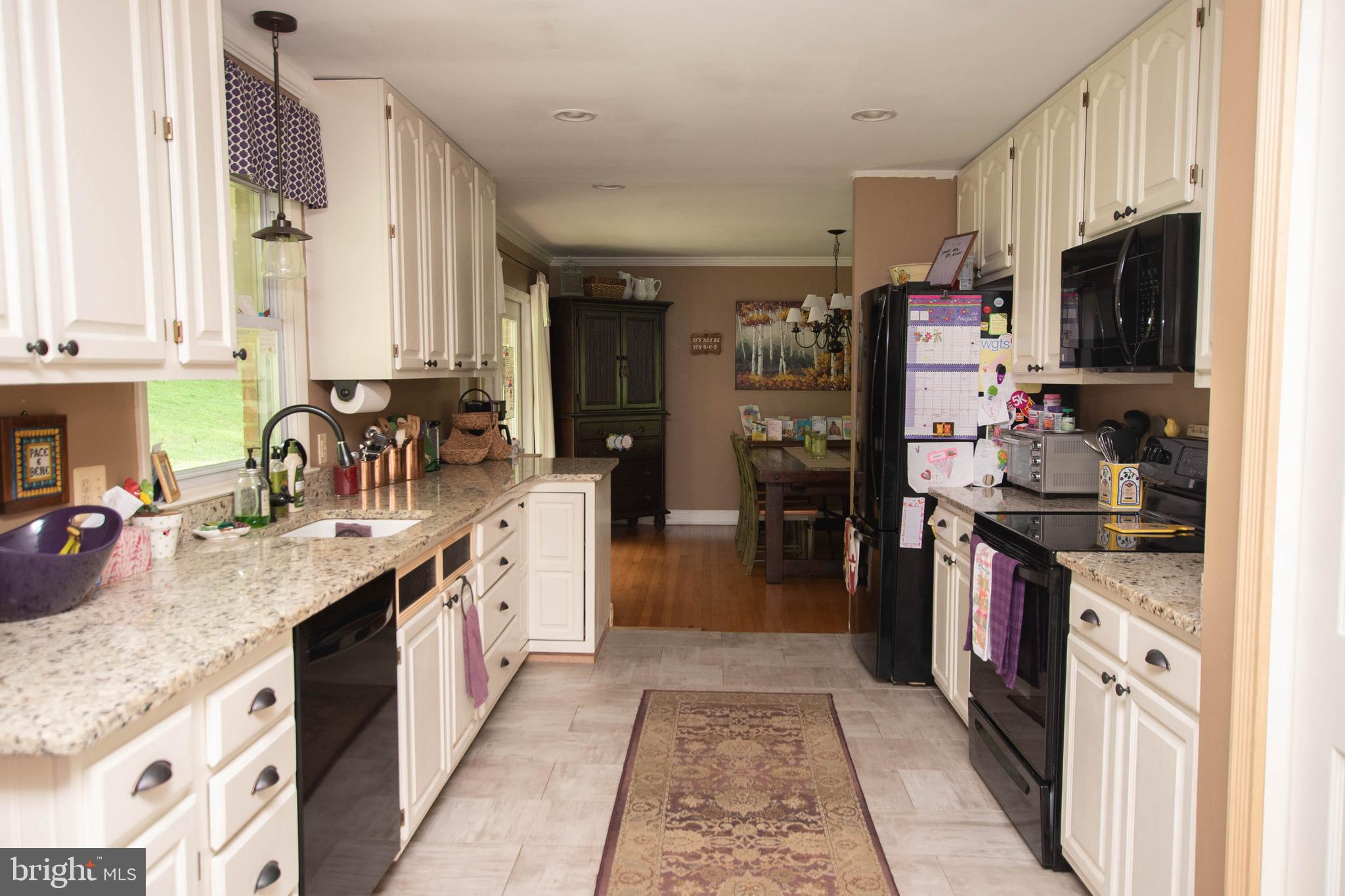 4721 Reels Mill Road Frederick, MD 21704 - Photo 22 of 42 a kitchen with stainless steel appliances granite countertop a refrigerator and a stove top oven