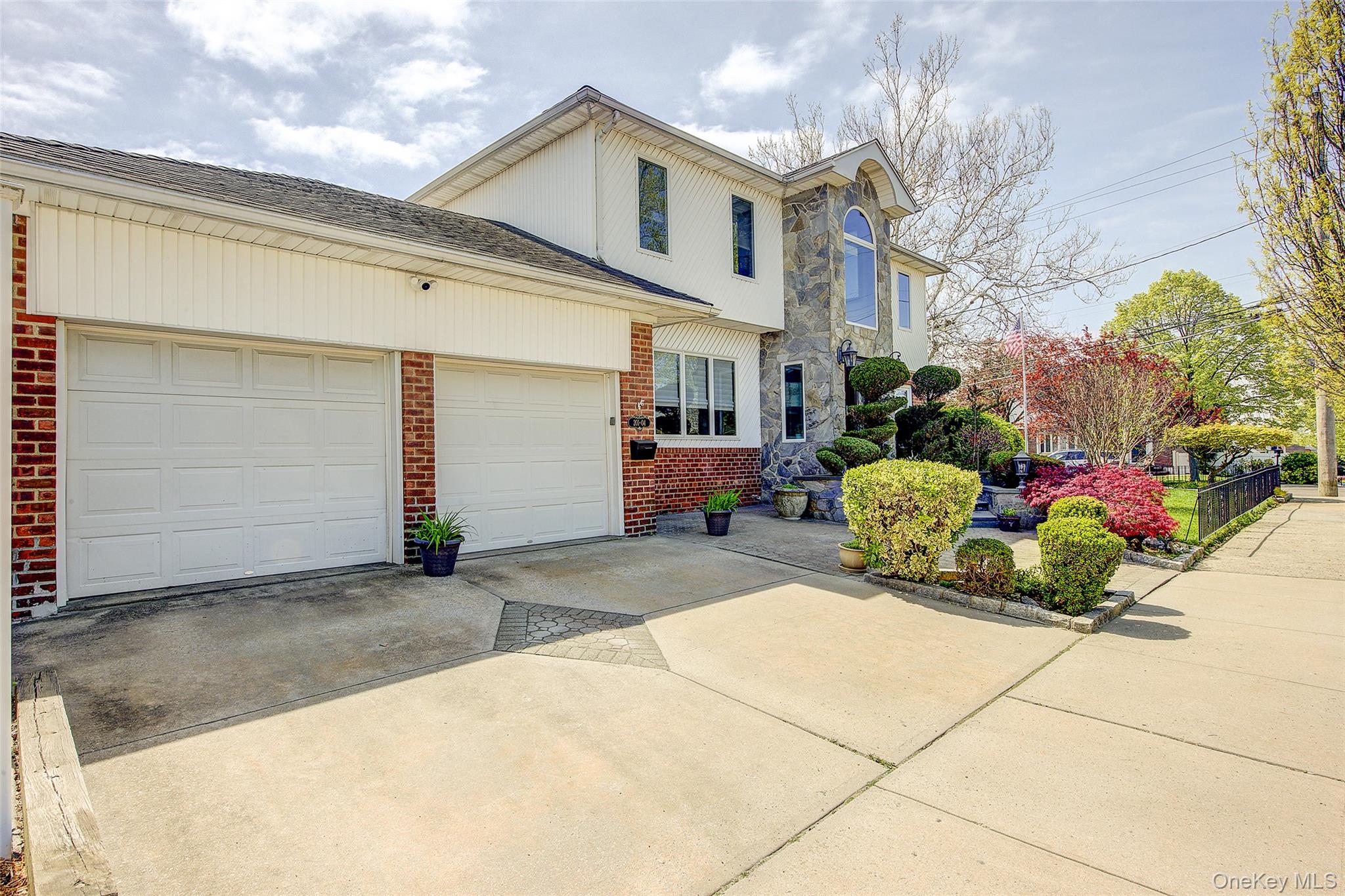 201-04 24th Road Queens, NY 11360 - Photo 2 of 50 Front of house with view of attached two car garage