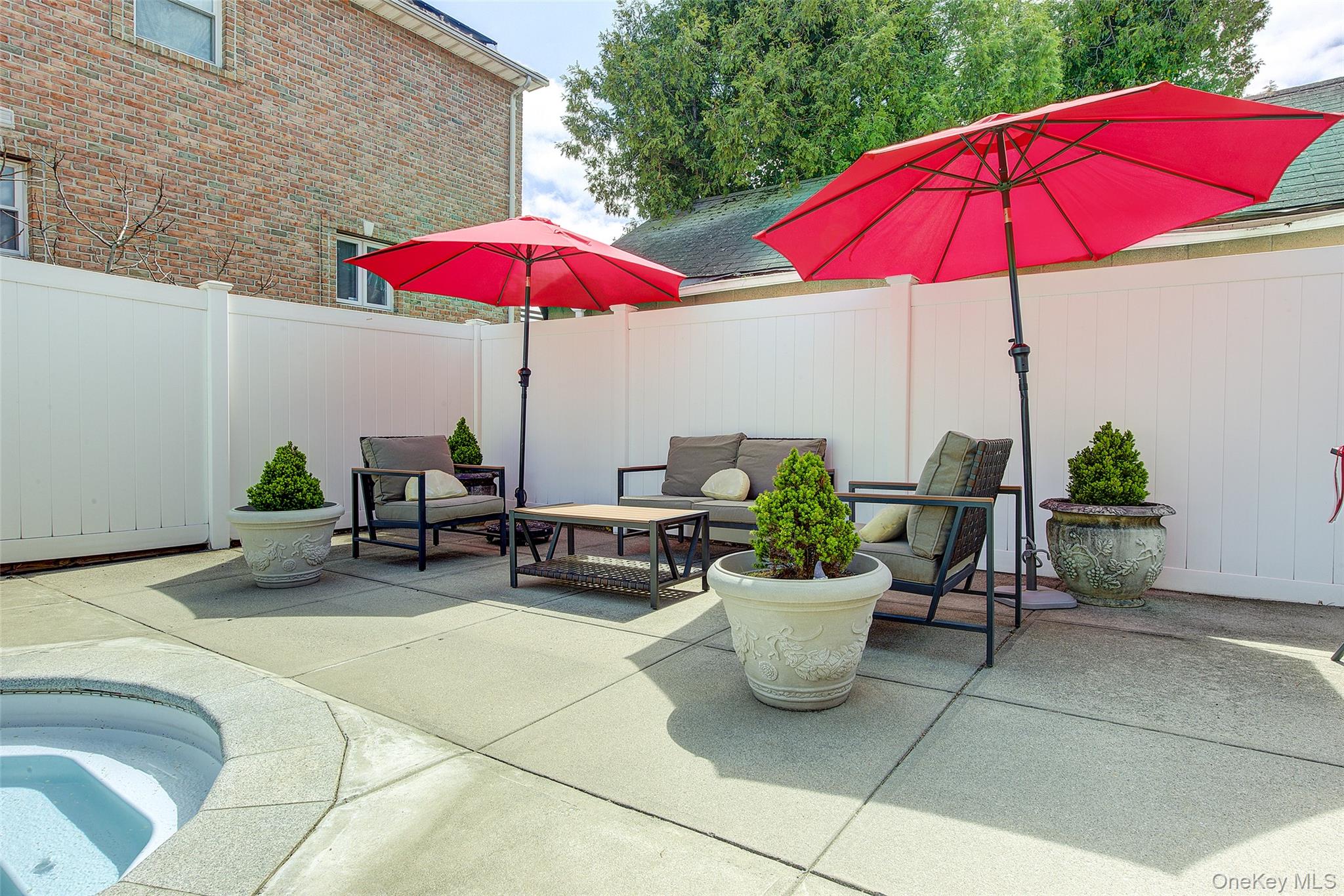 201-04 24th Road Queens, NY 11360 - Photo 44 of 50 Eating / lounging area in the backyard with view of pool