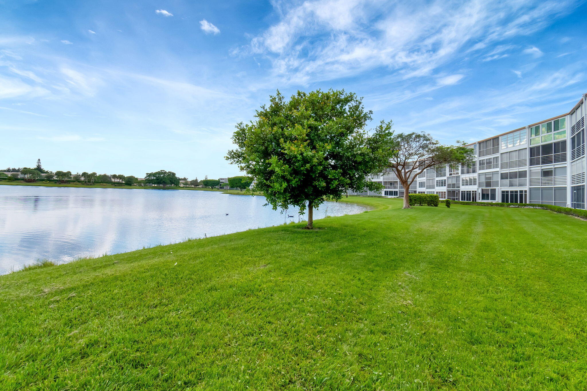 3031 Cornwall East Boca Raton, FL 33434 - Photo 31 of 84 a view of a lake with houses in the background
