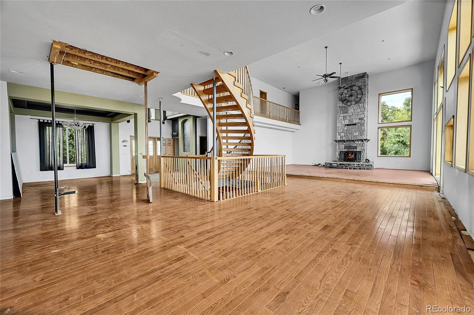 13058 South Ridge Road Conifer, CO 80433 - Photo 4 of 7 a view of a living room and kitchen with furniture floor to ceiling window