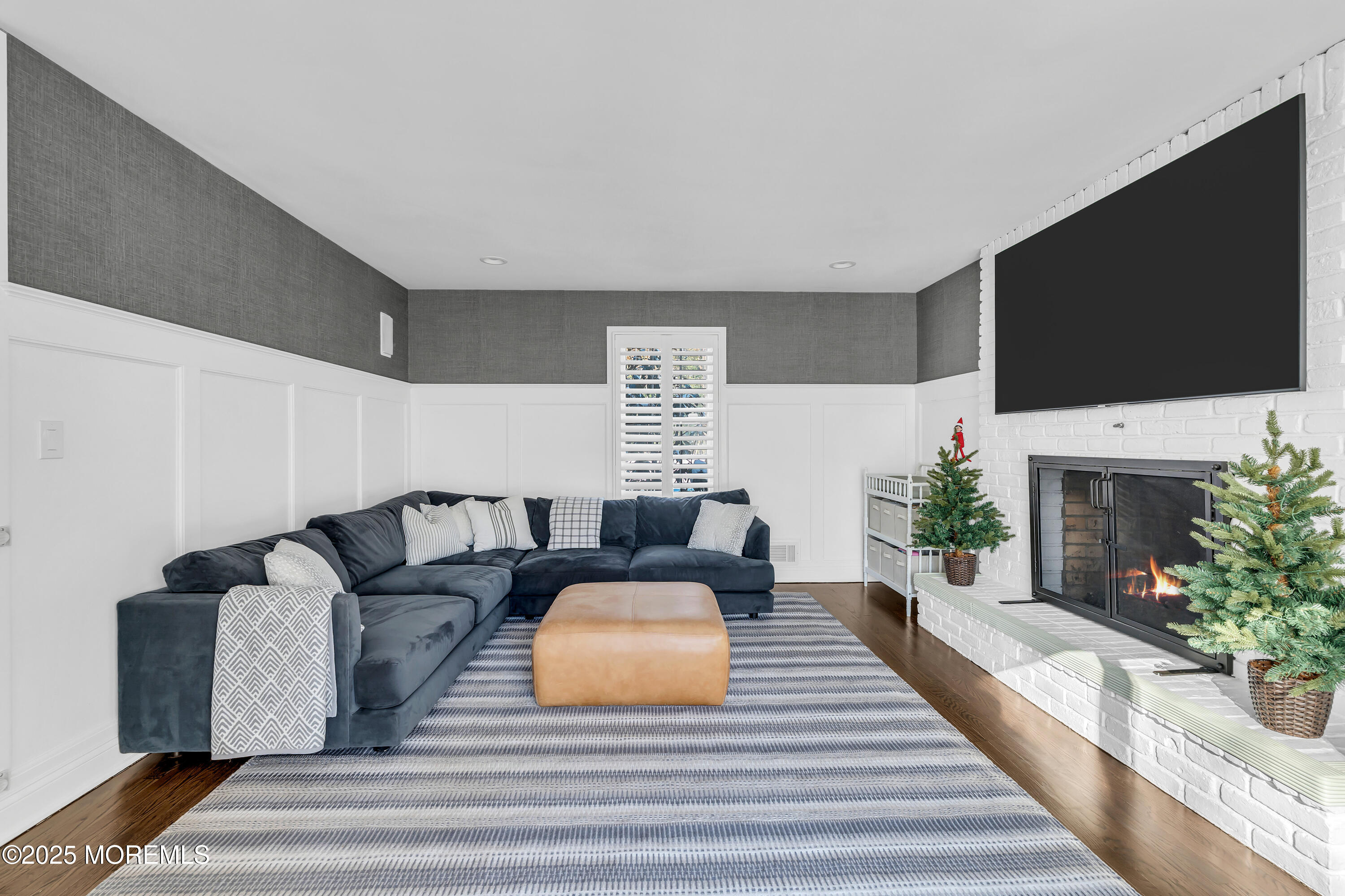 91 Lewis Point Road Fair Haven, NJ 07704 - Photo 23 of 58 a living room with furniture a fireplace and a flat screen tv