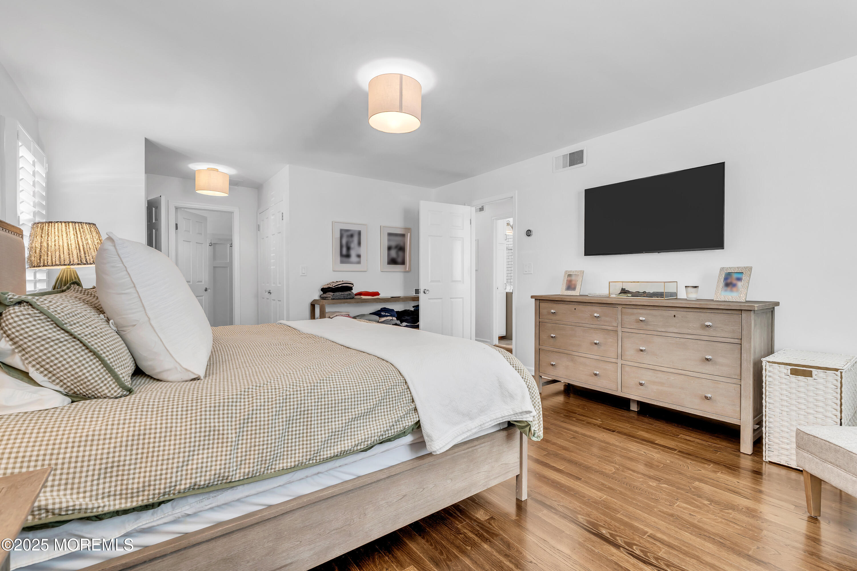 91 Lewis Point Road Fair Haven, NJ 07704 - Photo 29 of 58 a bedroom with a bed and a flat screen tv