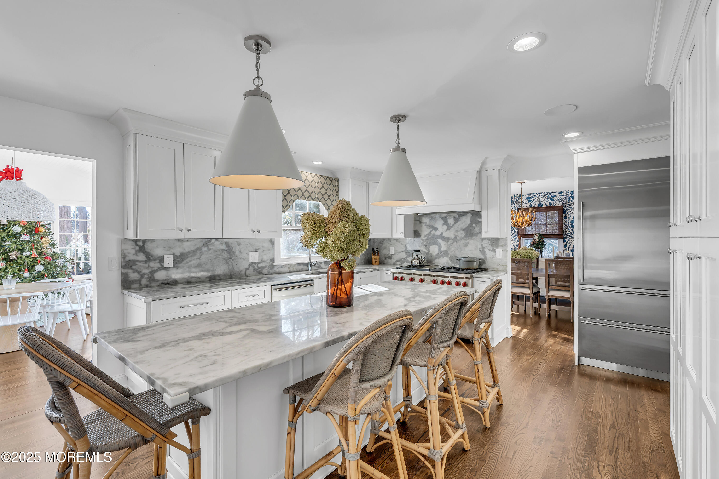 91 Lewis Point Road Fair Haven, NJ 07704 - Photo 10 of 58 a kitchen with stainless steel appliances granite countertop a kitchen island a stove a table and chairs in it