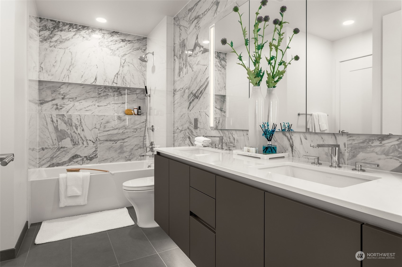 2510 6th Avenue, Unit 2410 Seattle, WA 98121 - Photo 14 of 36 a bathroom with a double vanity sink toilet and shower