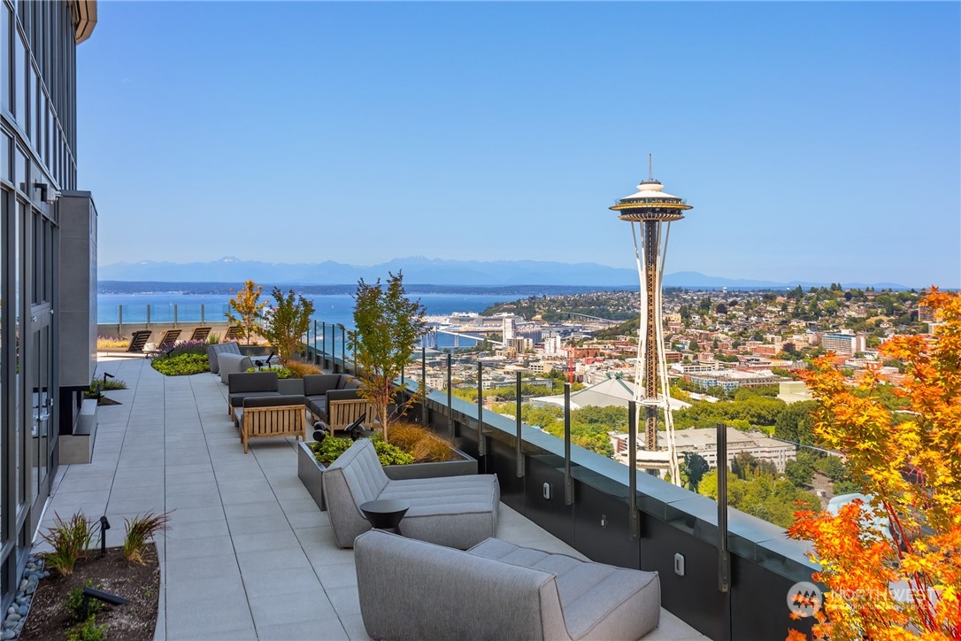 2510 6th Avenue, Unit 2410 Seattle, WA 98121 - Photo 30 of 36 a view of a balcony with dining table and chairs
