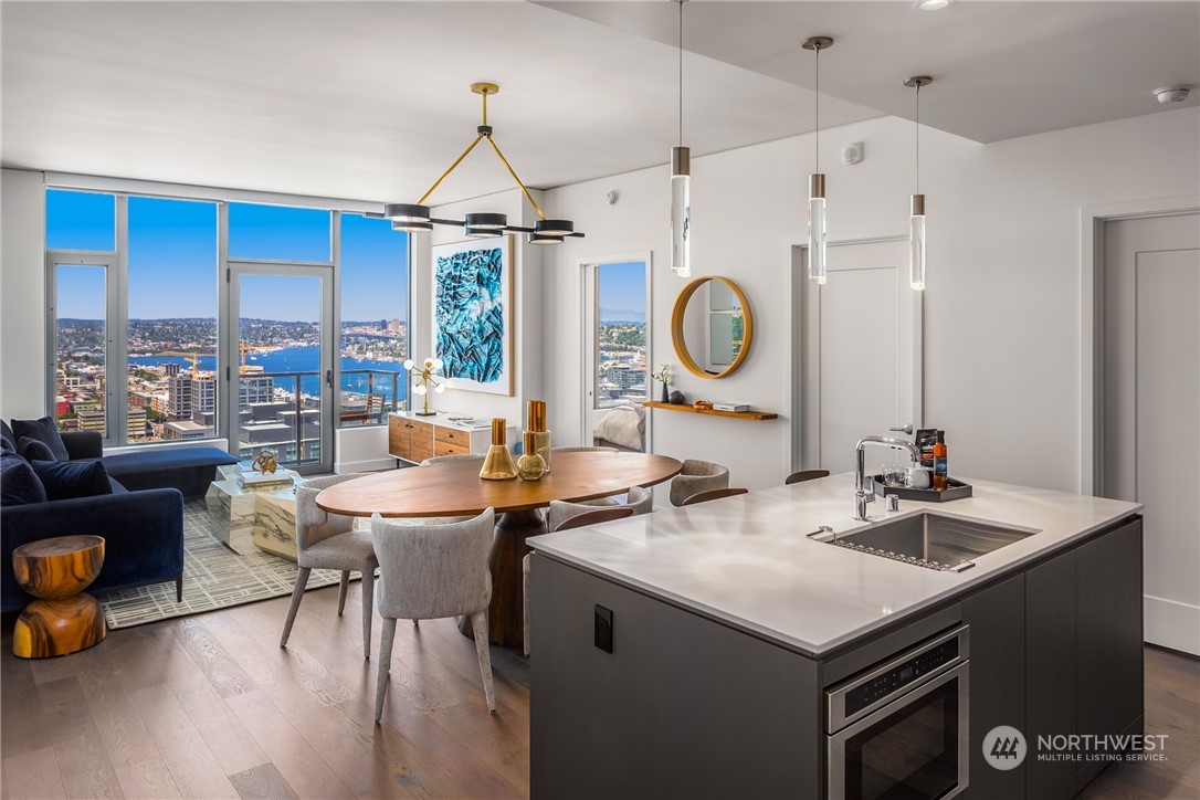 2510 6th Avenue, Unit 2410 Seattle, WA 98121 - Photo 5 of 36 a kitchen with a sink a stove and a table with chairs