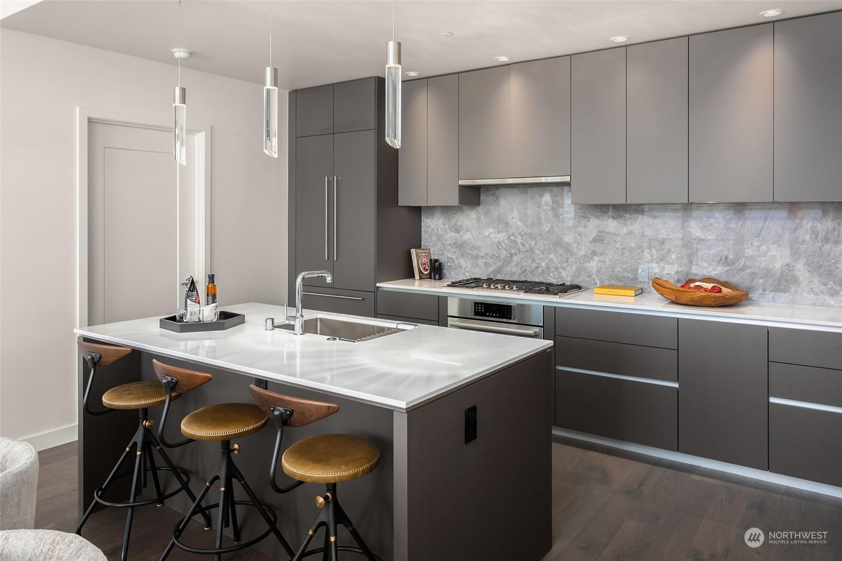 2510 6th Avenue, Unit 2410 Seattle, WA 98121 - Photo 6 of 36 a kitchen with a sink cabinets and wooden floor