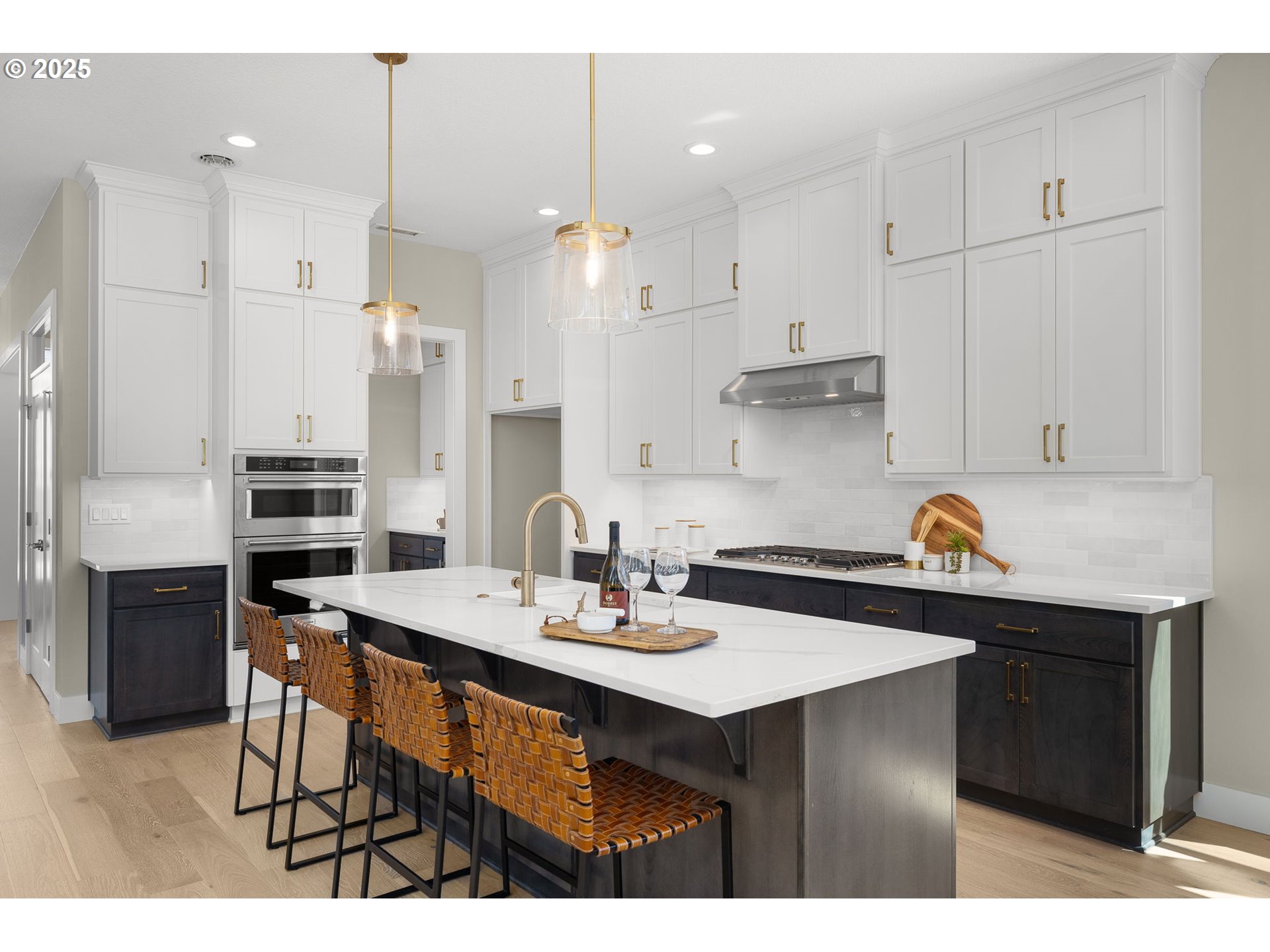 17839 Northwest Layla Drive, Unit LOT 12 Portland, OR 97229 - Photo 11 of 44 a kitchen with stainless steel appliances kitchen island a table chairs in it and wooden floors