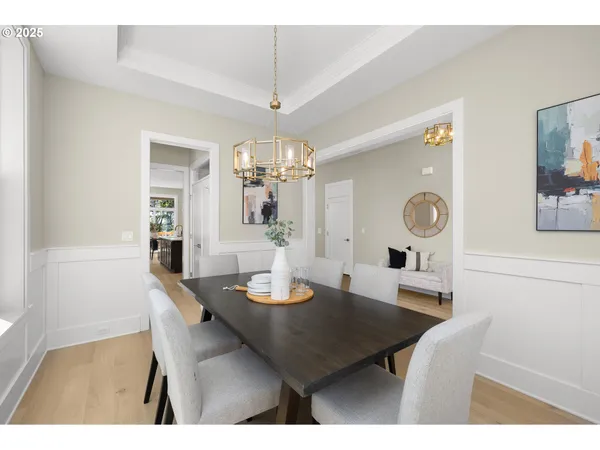 a view of a dining room with furniture and chandelier