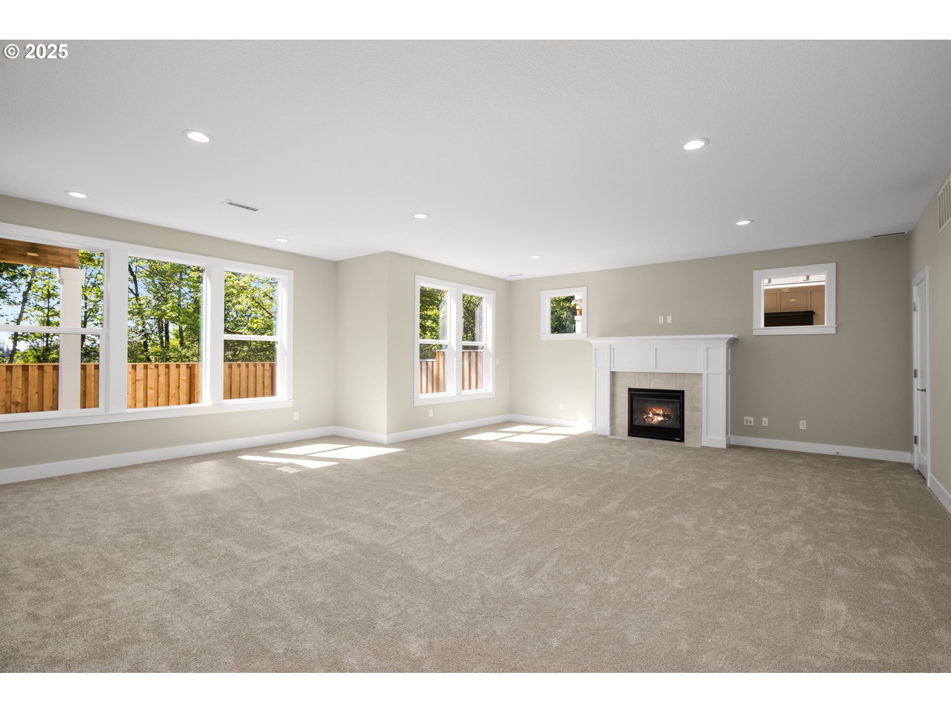 17839 Northwest Layla Drive, Unit LOT 12 Portland, OR 97229 - Photo 16 of 44 a view of empty room with fireplace and windows