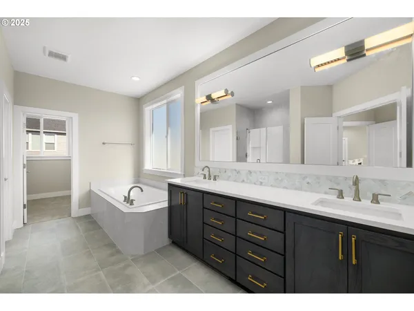 a spacious bathroom with a tub sink double vanity granite tub shower and mirror