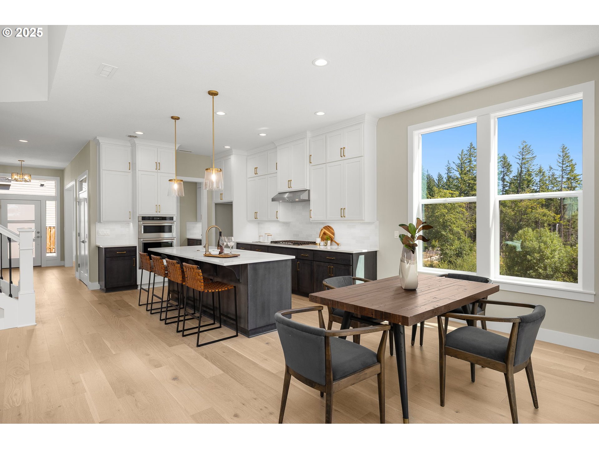 17839 Northwest Layla Drive, Unit LOT 12 Portland, OR 97229 - Photo 7 of 44 a open dining room with stainless steel appliances kitchen island granite countertop a dining table chairs and a living room view