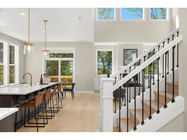 a dining room with furniture window entryway and wooden floor